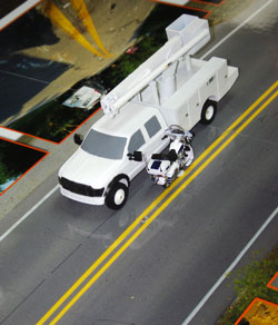 Image of scale model exhibit with scale vehicles located at the collision area.